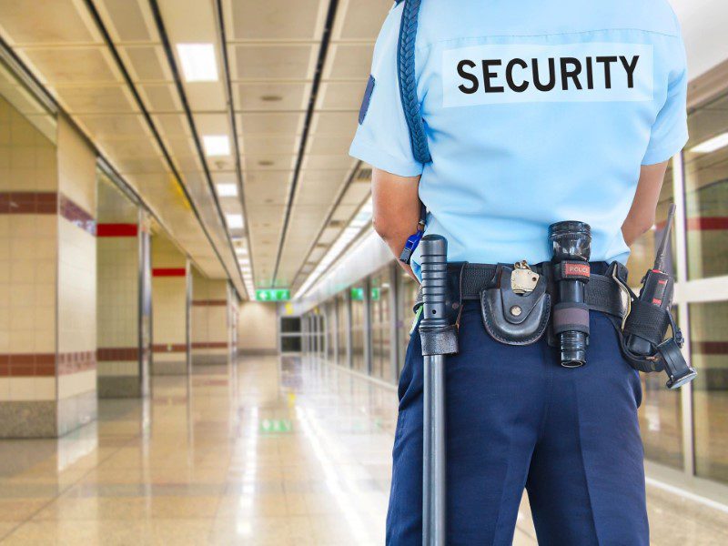 A security guard standing in an empty building.