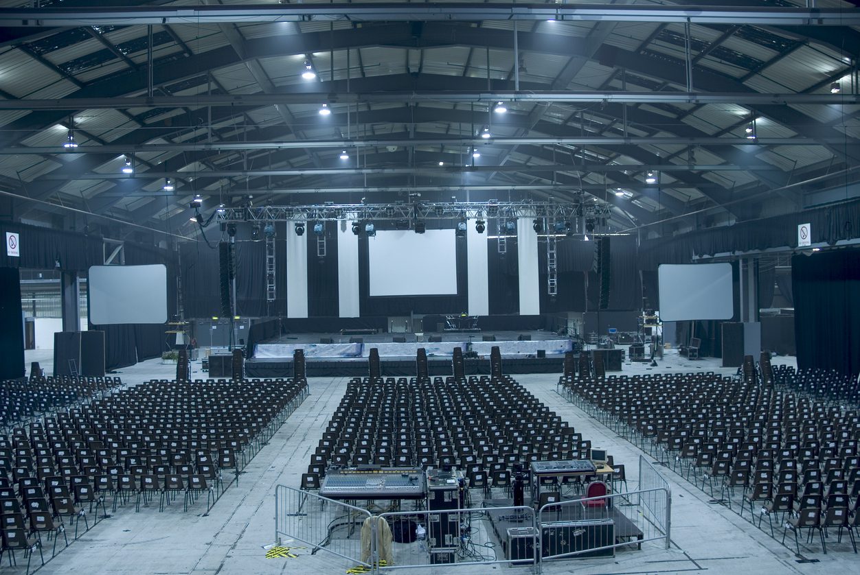 A music arena just after the stage has been set up and before the equipment is set up